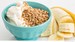 bowl of greek yougurt with cereal and banana