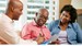 Financial-advisor-talking-to-senior-couple-at-home